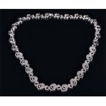 An 18ct white gold and diamond necklace comprising of graduated diamond set double and triple loop-