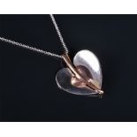 A white and rose metal heart-shaped pendant (tests as gold) the heart-shaped white mount set with