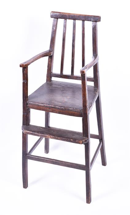 A childs 18th century elm high chair of simple naive form, the triple spindle back with open arms, - Image 3 of 4