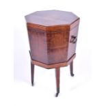 A fine George III octagonal wine cooler with cross-banded decoration, the tapering sides with oval