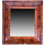 An 18th century oyster wood wall mirror the cushion shaped frame with moulded edges, and fitted with