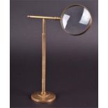 A brass framed French desk lens 25.5 cm high.