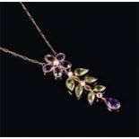 A yellow metal, amethyst, peridot, and pearl pendant of naturalistic design, with an amethyst flower