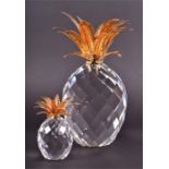 A Swarovski Giant crystal pineapple with gold plated leaves and faceted body, designed by Max