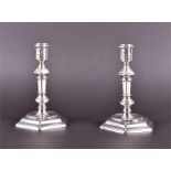 A rare pair of George I silver candlesticks London 1721, with knopped tapered columns supported on