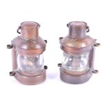 A pair of small bulkhead lamps in brass with glass bulb and burners, 22 cm high.