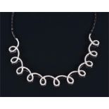 An 18ct white gold and diamond loop link necklace the looped mount set with round brilliant cut