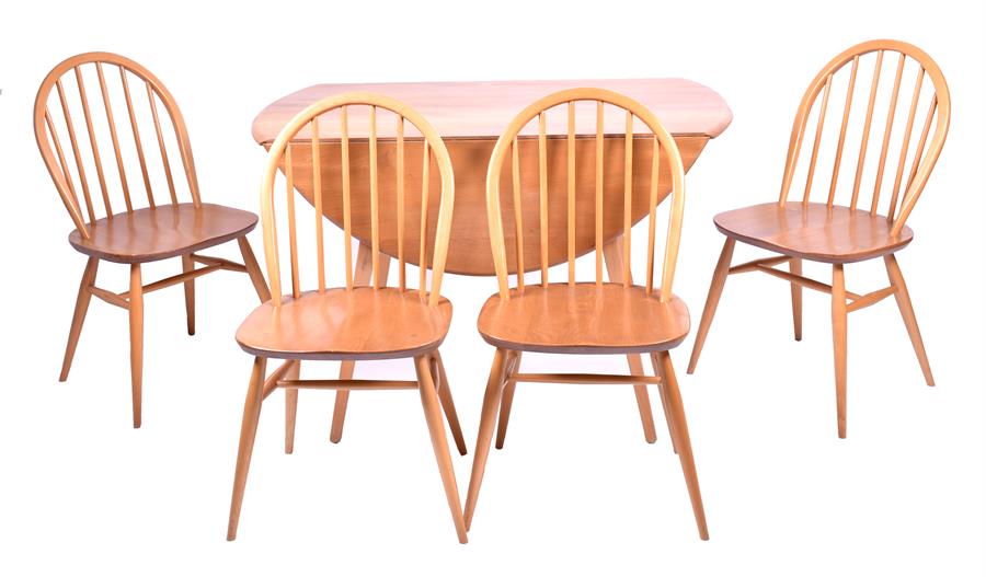 A 20th century pale Ercol dining suite comprising a gateleg dining table on tapering swept legs,