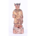 An early 20th century Chinese carved and gilded guardian figure in standing pose and holding a