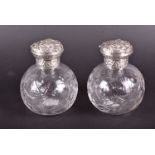 A pair of Victorian globe-shaped silver capped scent bottles London 1894 by Williams Comyns, with