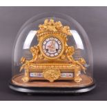 A 19th century French ormolu mantel clock with glass dome the ornately gilded case decorated with