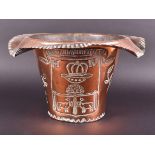 A large copper planter with embossed coat-of-arms with the Latin motto 'Urbis palladium et gentis'