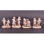 Four Meissen putti figural groups, to include two winged cherubs picking grapes (numbers to base 29,