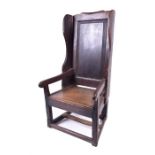 A Welsh 18th century oak lambing chair c.1750, of naive form, with panelled back, open curved