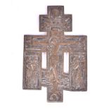 A 19th century Russian brass Christian icon detailing the crucifixion with script, decorated verso