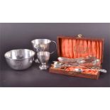 An assortment of silver items to include an engraved footed cup and egg cup both initialled and