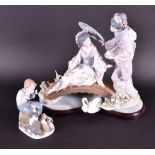 A Lladro figural group of two Japanese maidens one seated, one standing, on a stylised bridge with