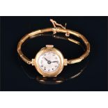 An 18ct yellow gold ladies cocktail watch the round glass-fronted case enclosing Roman numeral dial,