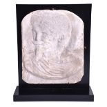 A mid 19th century carved marble plaque Napoleon III in relief wearing a laurel wreath, incised