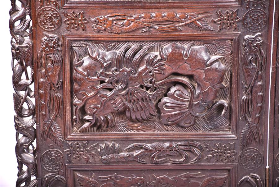 A large and impressive early 20th century Oriental hardwood screen the three panels elaborately - Image 11 of 17