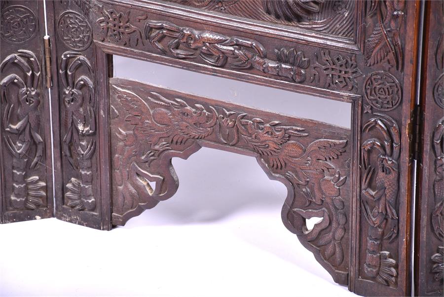 A large and impressive early 20th century Oriental hardwood screen the three panels elaborately - Image 9 of 17