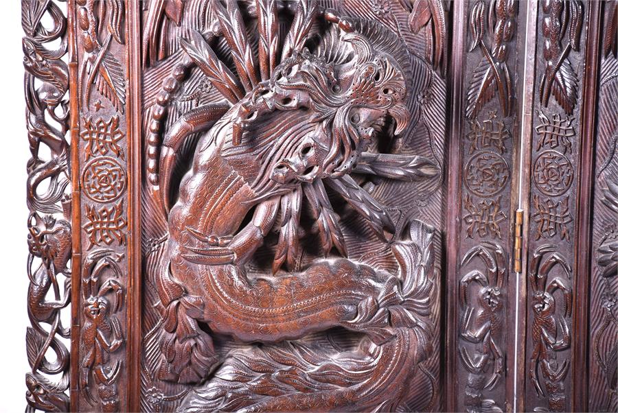 A large and impressive early 20th century Oriental hardwood screen the three panels elaborately - Image 3 of 17