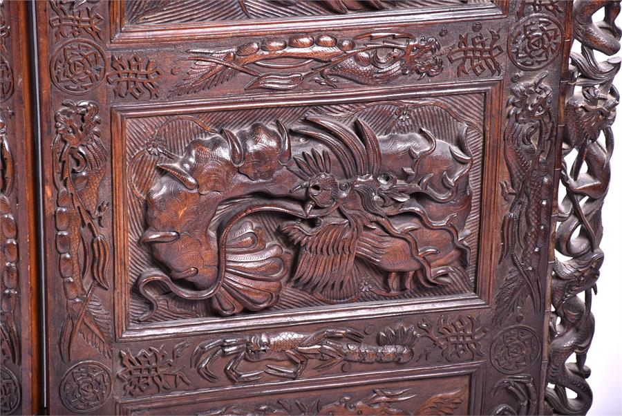 A large and impressive early 20th century Oriental hardwood screen the three panels elaborately - Image 8 of 17
