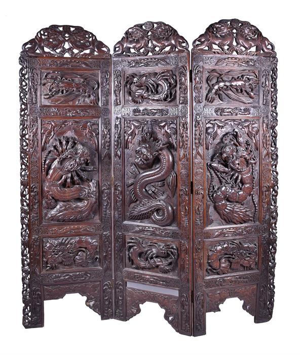 A large and impressive early 20th century Oriental hardwood screen the three panels elaborately