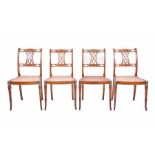 A set of four 19th century Sheraton Revival satinwood chairs each with cane seats and finely painted