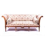 A late 19th century French fruitwood scroll end settee with loose fitted visions, a carved show wood
