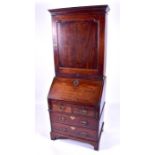 A charming George III mahogany bureau bookcase of small proportions the top with panelled door