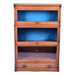 An oak Globe Wernicke bookcase in three sections with glazed sliding doors, the two top sections