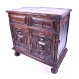 An 18th century oak chest the plain top with moulded rim, over a single drawer with panelled