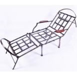 A designer cut steel patio campaign style lounger with lattice-work steel seat and back, and
