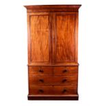 A large Georgian mahogany linen press the top with a pair of panel doors, the interior with