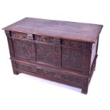 An 18th century oak coffer the plain top opening to reveal a green baize lined interior, the front