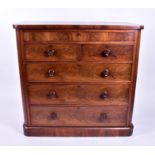 A large Victorian flame mahogany chest of drawers comprising one long concealed drawer over two