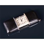 An Art Deco Movado Ermeto silver and black enamel travel / bag watch the silvered dial with blued