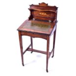 A small Edwardian rosewood writing desk with leather inset writing slope opening to reveal pigeon