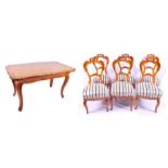 A Victorian figured satinwood dining table and six chairs the table with shaped top and finely