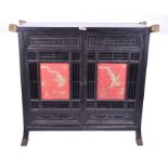 A large late 19th / early 20th century Japanese stained hardwood cabinet  the panelled doors with
