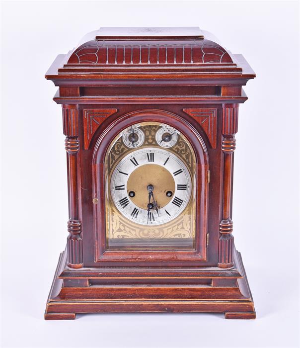 A 20th century bracket clock set within a stained mahogany case with hinged glazed panel door, the