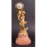 A 19th century French ormolu figural ball clock formed as a cherub holding aloft a star-studded