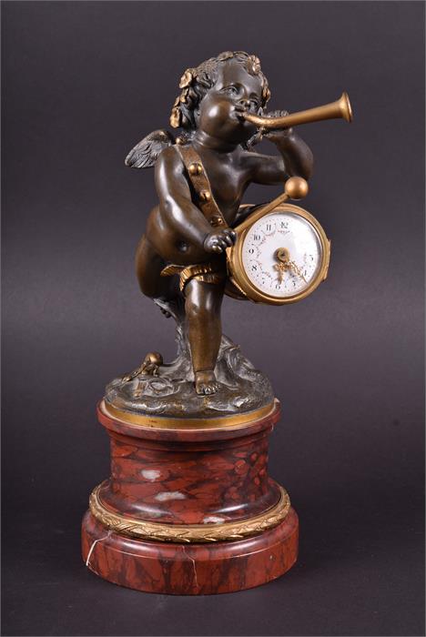 A 19th century French marble figural cherub mantel clock the cherub playing a horn and holding a