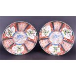A large pair of Japanese Meiji period Imari chargers a blue foo dog to the centres with gilt and