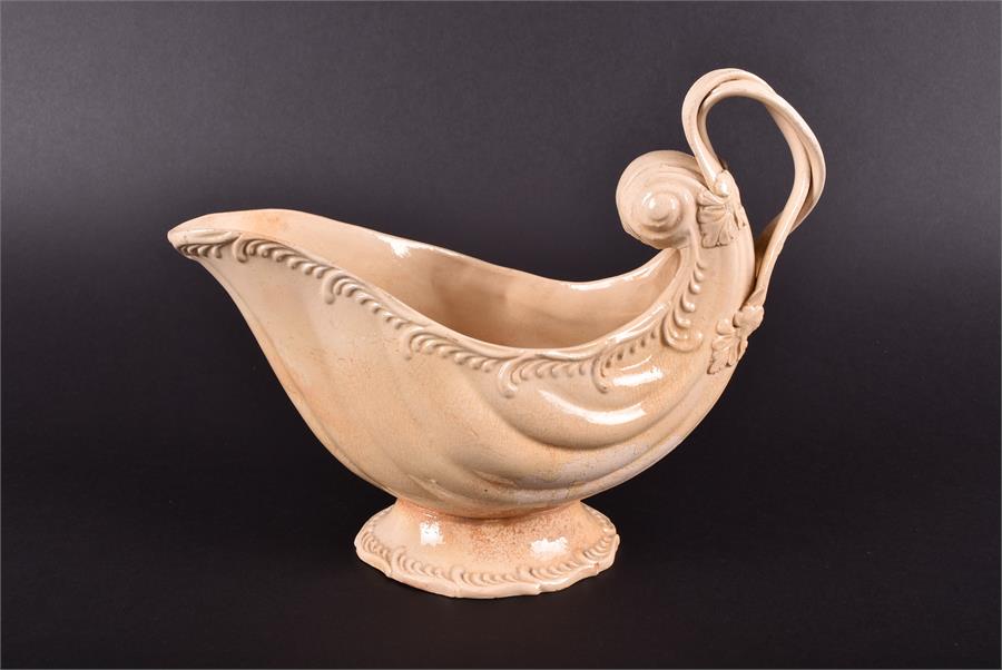 An 18th century creamware shell shaped sauce boat the rim with moulded scrolled decoration, with - Image 4 of 6