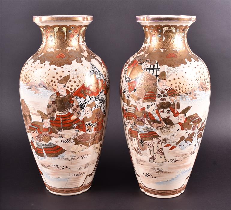 A pair of early 20th century Japanese Satsuma vases of tapered form, decorated with panels of