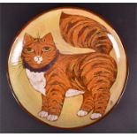 A studio pottery low bowl by Barbara Ross decorated with a plump ginger cat wearing a purple