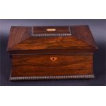 A Regency rosewood veneered sarcophagus shaped tea caddy the hinged lid revealing a fitted