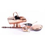 Four copper items, including a coal scuttle a deep, heavy bottomed frying pan, a long-handled pan